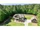 Wide aerial view of gorgeous home and detached garage surrounded by lush, mature trees at 105 Chantilly Ln, Fayetteville, GA 30215