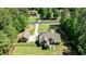 An aerial perspective of a secluded home featuring a detached garage, fenced-in yard, surrounded by mature trees at 105 Chantilly Ln, Fayetteville, GA 30215