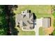 An overhead shot of the home with its detached garage and patio, framed by mature trees and lush lawn at 105 Chantilly Ln, Fayetteville, GA 30215