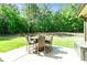 Backyard patio with outdoor dining set and expansive lawn at 105 Chantilly Ln, Fayetteville, GA 30215