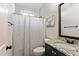 Bathroom features a granite vanity top and a shower-tub combination with a striped shower curtain at 105 Chantilly Ln, Fayetteville, GA 30215