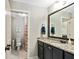 Clean bathroom featuring granite countertops, dark cabinetry, and tiled shower at 105 Chantilly Ln, Fayetteville, GA 30215