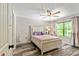 Cozy bedroom with natural light, neutral color palette, and laminate wood flooring at 105 Chantilly Ln, Fayetteville, GA 30215