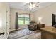 Bedroom featuring a comfortable chair, natural light, and laminate wood flooring at 105 Chantilly Ln, Fayetteville, GA 30215