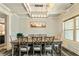 Formal dining room with decorative trim, modern chandelier, and a large window providing natural light at 105 Chantilly Ln, Fayetteville, GA 30215