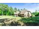 A spacious backyard that features a screened-in porch, patio, and lush lawn at 105 Chantilly Ln, Fayetteville, GA 30215