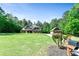 A large home with a lush front lawn, a detached garage, and mature landscaping at 105 Chantilly Ln, Fayetteville, GA 30215