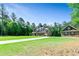 Exterior view of a home with a long driveway, detached garage, and lush front yard at 105 Chantilly Ln, Fayetteville, GA 30215