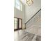 Bright foyer with hardwood floors, wainscoting, black iron stair railing, and a contemporary light fixture at 105 Chantilly Ln, Fayetteville, GA 30215