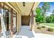 Inviting front porch with brickwork and beautiful glass paned door at 105 Chantilly Ln, Fayetteville, GA 30215