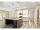 Stylish kitchen with a large island, stainless steel appliances, and sleek black cabinetry at 105 Chantilly Ln, Fayetteville, GA 30215