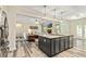 Open kitchen with island, stainless appliances, and seamlessly connected to the living area at 105 Chantilly Ln, Fayetteville, GA 30215