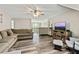 Spacious living room featuring modern flooring, large sectional couch, and lots of natural light at 105 Chantilly Ln, Fayetteville, GA 30215