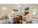 Bright living room featuring a fireplace, neutral furniture, and large windows offering ample natural light at 105 Chantilly Ln, Fayetteville, GA 30215