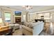 Open living room with a brick fireplace, hardwood floors, and a view to the kitchen at 105 Chantilly Ln, Fayetteville, GA 30215