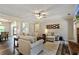Inviting living room with hardwood floors, fireplace, open archway, and neutral decor at 105 Chantilly Ln, Fayetteville, GA 30215
