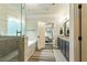 Main bathroom with a glass shower, soaking tub, double vanity, and entry to the main bedroom at 105 Chantilly Ln, Fayetteville, GA 30215
