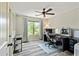 Well-lit office space with large window, modern desk, and laminate wood flooring at 105 Chantilly Ln, Fayetteville, GA 30215