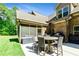 Outdoor patio featuring a table with seating, screened porch, and a grilling area at 105 Chantilly Ln, Fayetteville, GA 30215