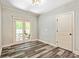 Neutral room features a double door leading to an outdoor patio and a contrasting wood plank floor at 105 Chantilly Ln, Fayetteville, GA 30215