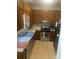 Traditional kitchen featuring wood cabinetry, stainless steel appliances, and tile flooring at 1500 Country Ct, Auburn, GA 30011