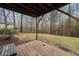 Covered wooden deck offering scenic views of the property's lush backyard and wooded surroundings at 162 Brookhaven Way, Rockmart, GA 30153