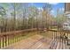 Wooden back deck offering serene view of lush greenery and tree line in backyard at 162 Brookhaven Way, Rockmart, GA 30153
