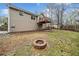 Spacious backyard featuring a fire pit, two-story home, and small wooden deck at 162 Brookhaven Way, Rockmart, GA 30153