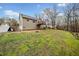 Large backyard with a basketball hoop, two-story home, wooden deck, and additional storage shed at 162 Brookhaven Way, Rockmart, GA 30153