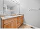 Bathroom featuring a double sink vanity with cabinets and a large mirror with lighting above at 162 Brookhaven Way, Rockmart, GA 30153