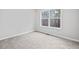 Cozy bedroom with plush carpeting, a window with natural light, and neutral decor for a serene atmosphere at 162 Brookhaven Way, Rockmart, GA 30153
