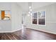 Dining room with hardwood floors, modern lighting, and a view to the back yard at 162 Brookhaven Way, Rockmart, GA 30153