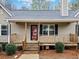 Inviting front porch with wood railing, stairs, and decorative plants leading to the entrance of the home at 162 Brookhaven Way, Rockmart, GA 30153