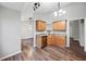 View of kitchen featuring a sink, dishwasher, wooden cabinets, and hardwood floors at 162 Brookhaven Way, Rockmart, GA 30153