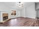 Spacious living room showcasing new floors and a stone fireplace, offering a cozy and inviting atmosphere at 162 Brookhaven Way, Rockmart, GA 30153