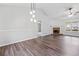 Open-concept living area featuring a fireplace, hardwood floors, and neutral paint at 162 Brookhaven Way, Rockmart, GA 30153