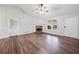 A bright living room showcases new floors and a stone fireplace, creating a cozy and inviting atmosphere at 162 Brookhaven Way, Rockmart, GA 30153