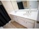 Bathroom featuring double sinks with white cabinetry and ceramic tile flooring at 2548 Gadsen Walk, Duluth, GA 30097