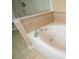 A close up of a jacuzzi style tub with tile accents and chrome fixtures at 2548 Gadsen Walk, Duluth, GA 30097