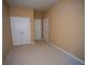 Neutral carpeted bedroom with double closet doors for storage at 2548 Gadsen Walk, Duluth, GA 30097