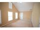 Bright carpeted bedroom featuring a vaulted ceiling and three large windows at 2548 Gadsen Walk, Duluth, GA 30097