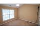 Bright bedroom featuring a large window and neutral carpeting at 2548 Gadsen Walk, Duluth, GA 30097