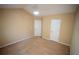 Neutral bedroom featuring tan carpet with white doors at 2548 Gadsen Walk, Duluth, GA 30097