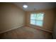 Bright bedroom featuring a window and neutral carpeting at 2548 Gadsen Walk, Duluth, GA 30097