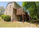 Exterior elevation featuring a brick facade and a large deck at 2548 Gadsen Walk, Duluth, GA 30097