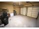 Spacious two-car garage with overhead door openers, storage shelves, and bare concrete floor at 2548 Gadsen Walk, Duluth, GA 30097