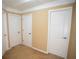 Hallway with three white doors and tan carpet at 2548 Gadsen Walk, Duluth, GA 30097