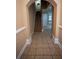 Spacious hallway with neutral tile flooring, leading to an open floor plan and staircase at 2548 Gadsen Walk, Duluth, GA 30097