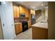 Well-equipped kitchen with wooden cabinetry, stainless steel appliances, and modern fixtures at 2548 Gadsen Walk, Duluth, GA 30097