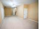 Spacious living room features neutral carpet, ceiling fan, and white trim throughout at 2548 Gadsen Walk, Duluth, GA 30097
